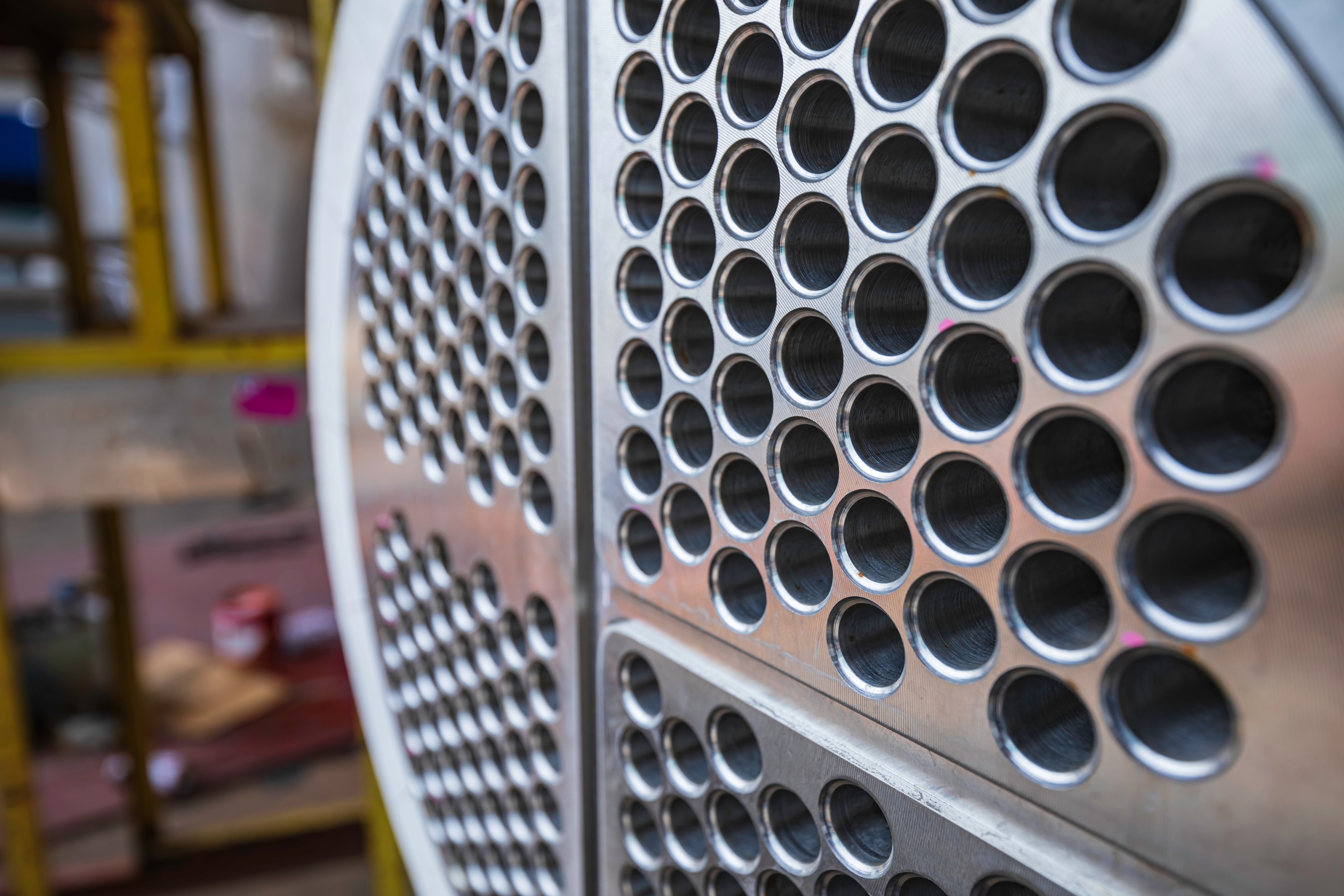 Precision-drilled tube sheet for heat exchanger fabrication
